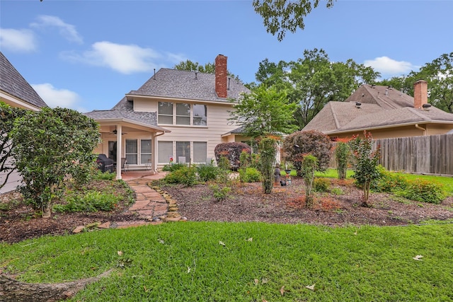5810 Redwood River Dr, Kingwood, TX 77345 - rear view of house featuring a ceiling fan, a patio area, and a chimney