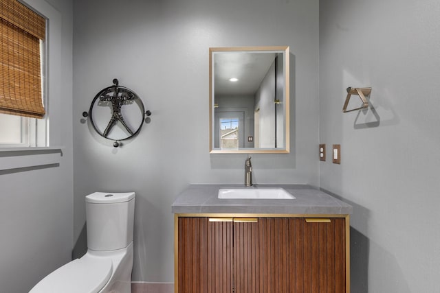 bathroom featuring toilet and vanity