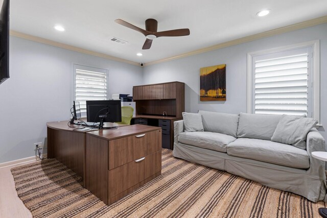 office space with a ceiling fan, recessed lighting, crown molding, baseboards, and light colored carpet