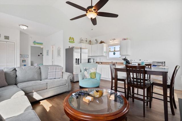 living room with a ceiling fan, wood finished floors, and high vaulted ceiling
