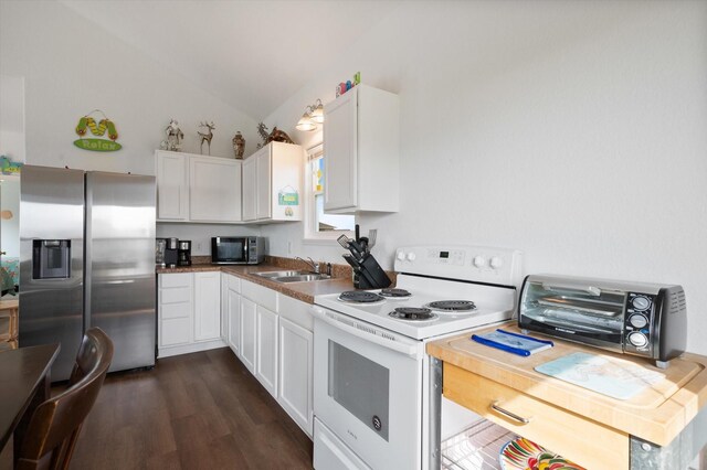 kitchen featuring electric range, stainless steel fridge, black microwave, a sink, and lofted ceiling