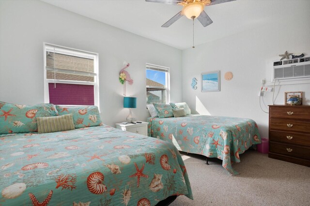 bedroom featuring carpet floors, a wall unit AC, and a ceiling fan