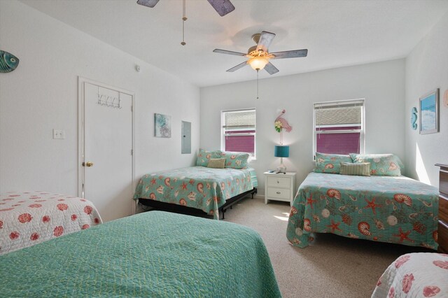 bedroom with carpet floors, electric panel, and a ceiling fan