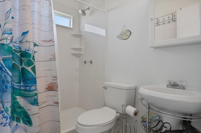 full bath with a shower stall and toilet