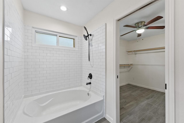 bathroom with shower / bath combination, a ceiling fan, a walk in closet, baseboards, and recessed lighting