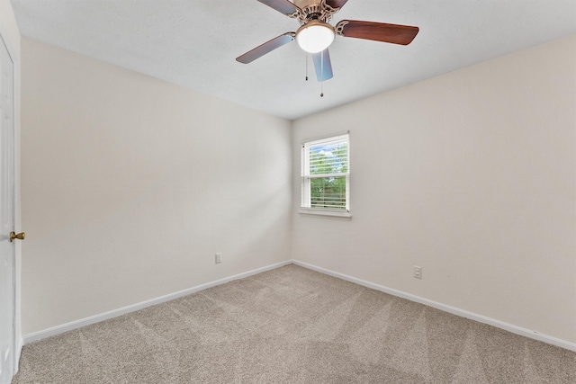 spare room featuring carpet flooring, baseboards, and a ceiling fan