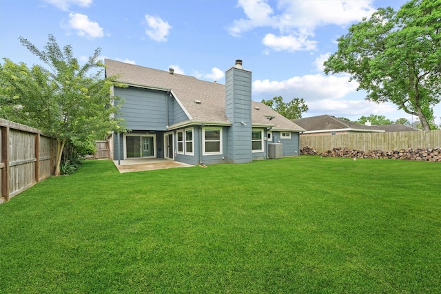 back of property featuring a patio, a chimney, and roof with shingles