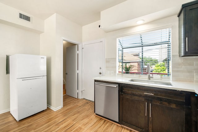 2100 Huldy St Unit 4, Houston, TX 77019 - kitchen with freestanding refrigerator, stainless steel dishwasher, a sink, light wood finished floors, and tasteful backsplash