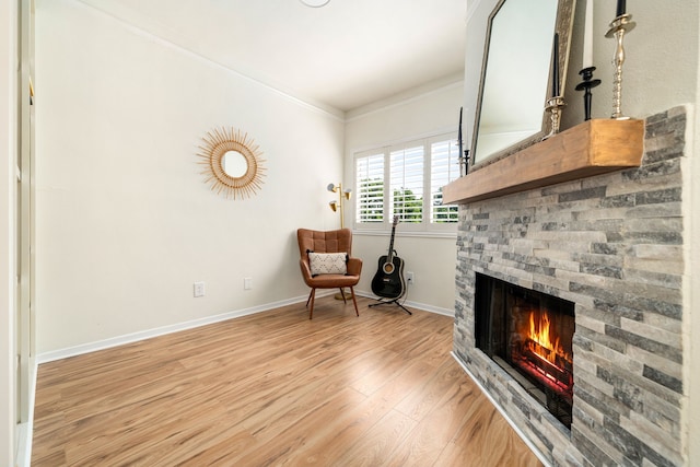2100 Huldy St Unit 4, Houston, TX 77019 - sitting room featuring a fireplace, light wood-style flooring, baseboards, and ornamental molding