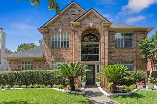 2112 Shadow Bay Cir, League City, TX 77573 - traditional home featuring brick siding, a front yard, and a shingled roof
