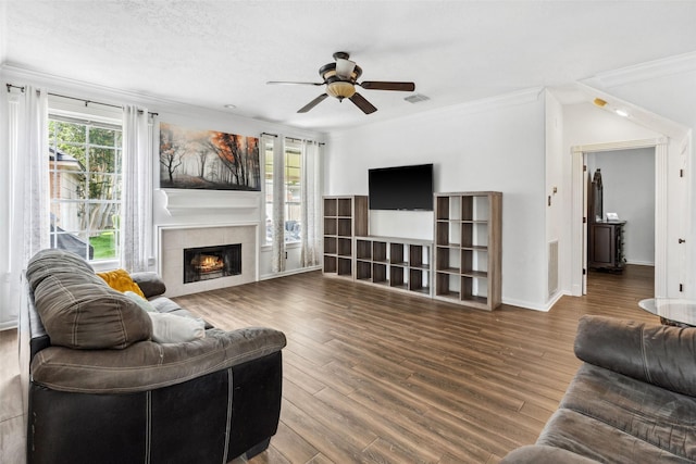2112 Shadow Bay Cir, League City, TX 77573 - living area featuring a ceiling fan, a tile fireplace, wood finished floors, ornamental molding, and baseboards