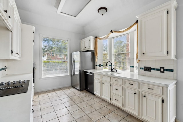 2112 Shadow Bay Cir, League City, TX 77573 - kitchen with a sink, dishwasher, black electric cooktop, stainless steel refrigerator with ice dispenser, and backsplash
