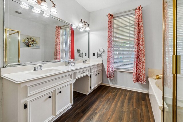2112 Shadow Bay Cir, League City, TX 77573 - full bathroom featuring plenty of natural light, wood finished floors, double vanity, and a garden tub