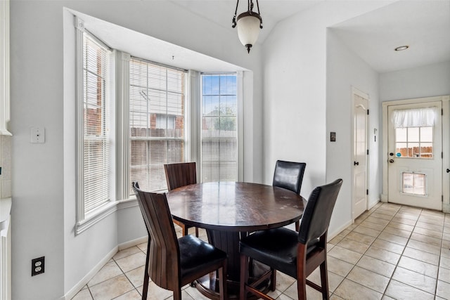 2112 Shadow Bay Cir, League City, TX 77573 - dining space with light tile patterned floors, plenty of natural light, and baseboards