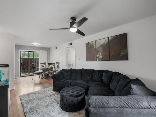 living area featuring wood finished floors and a ceiling fan