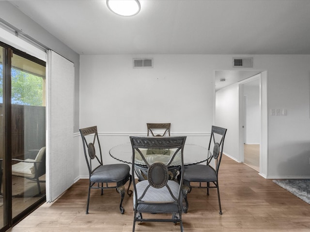 dining area featuring wood finished floors and baseboards