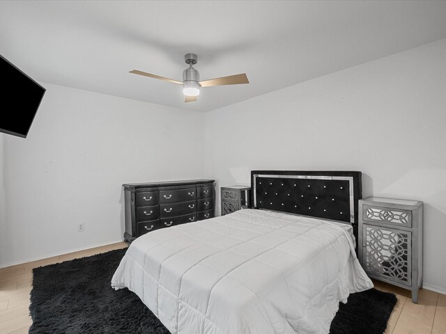 bedroom with wood finished floors and a ceiling fan