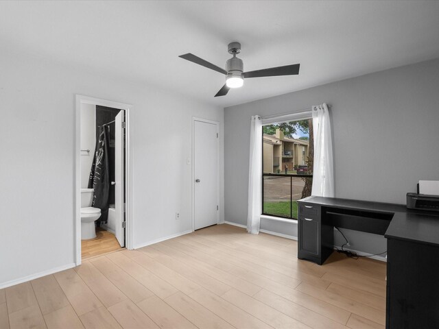 unfurnished office with a ceiling fan, light wood-style floors, and baseboards