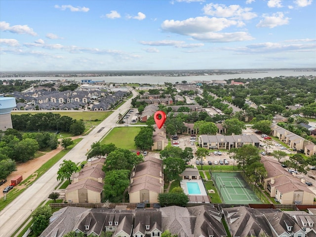 view of property location featuring a nearby body of water and nearby suburban area