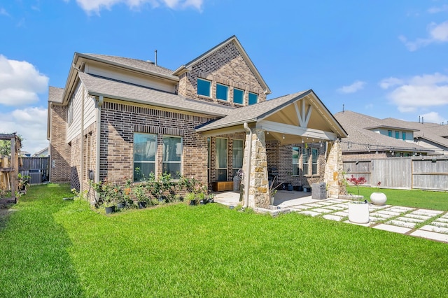 2723 Camellia Ave, Brookshire, TX 77423 - rear view of house with a patio area, brick siding, and roof with shingles