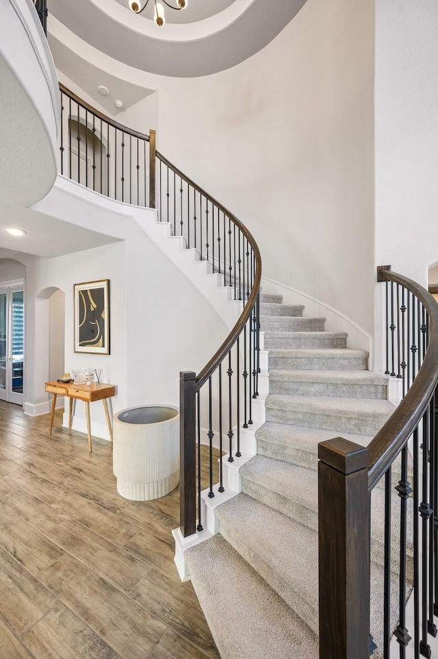 2723 Camellia Ave, Brookshire, TX 77423 - stairway with wood finished floors, arched walkways, a high ceiling, and baseboards