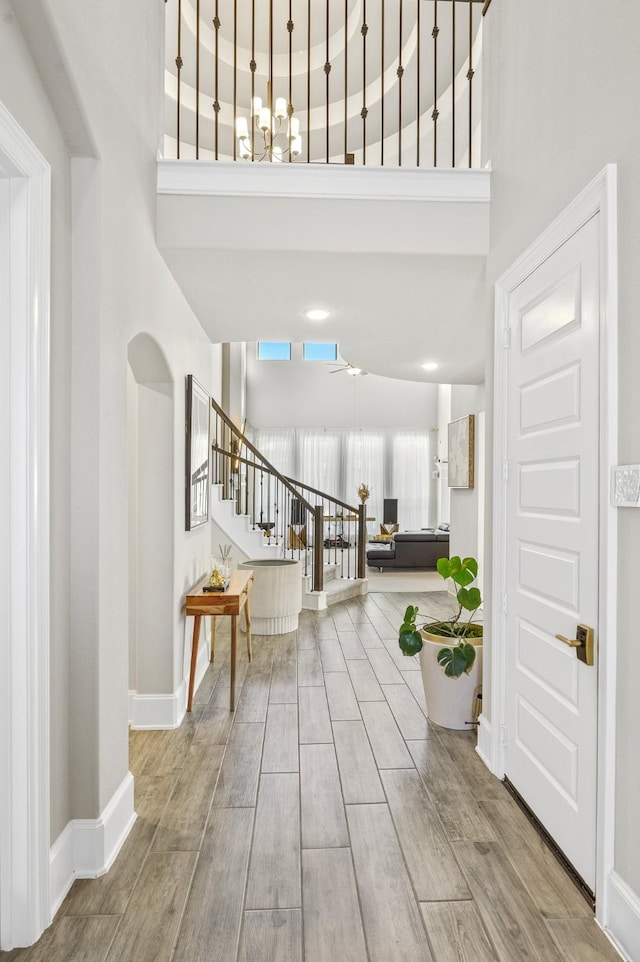 2723 Camellia Ave, Brookshire, TX 77423 - foyer entrance featuring a high ceiling, stairway, baseboards, a chandelier, and wood finished floors