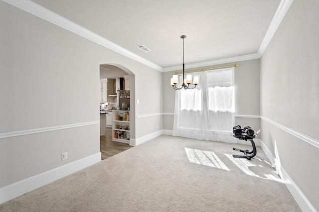 2723 Camellia Ave, Brookshire, TX 77423 - unfurnished dining area featuring crown molding, carpet, arched walkways, a chandelier, and baseboards