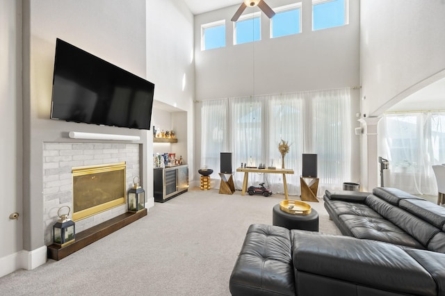 2723 Camellia Ave, Brookshire, TX 77423 - carpeted living area with a high ceiling, a ceiling fan, and a fireplace