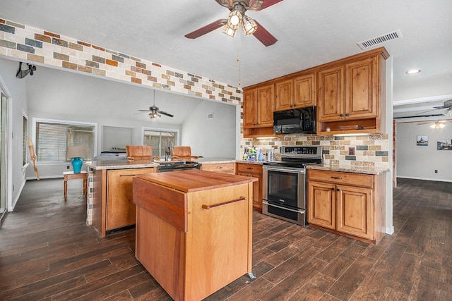 1727 Plumbwood Way, Houston, TX 77058 - kitchen with electric range, ceiling fan, black microwave, a peninsula, and butcher block counters