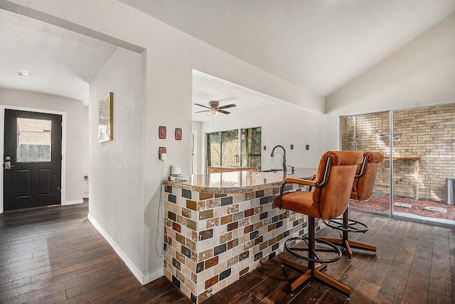 1727 Plumbwood Way, Houston, TX 77058 - bar with dark wood-style floors, healthy amount of natural light, baseboards, lofted ceiling, and a sink