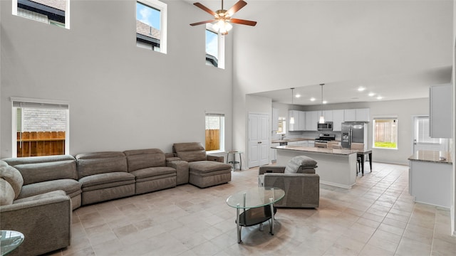 22218 Delphin Grove Dr, Hockley, TX 77447 - living area featuring a towering ceiling, ceiling fan, light tile patterned floors, and recessed lighting
