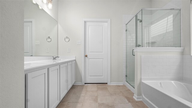 22218 Delphin Grove Dr, Hockley, TX 77447 - full bath with a stall shower, a garden tub, double vanity, baseboards, and tile patterned flooring