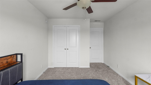 22218 Delphin Grove Dr, Hockley, TX 77447 - unfurnished bedroom featuring carpet flooring, a closet, baseboards, and a ceiling fan
