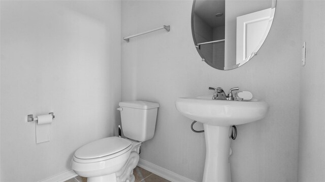 22218 Delphin Grove Dr, Hockley, TX 77447 - bathroom with toilet, baseboards, and tile patterned flooring