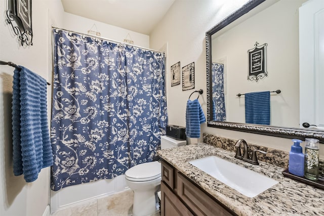 bathroom featuring tile patterned flooring, toilet, and vanity