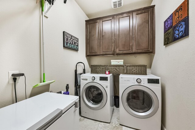 laundry room with washer and dryer and cabinet space