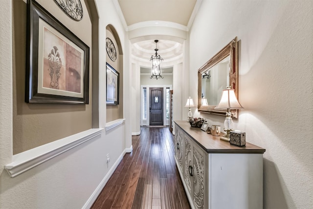 2103 Matagorda Ln, Friendswood, TX 77546 - hallway with crown molding, dark wood-style floors, baseboards, a chandelier, and arched walkways
