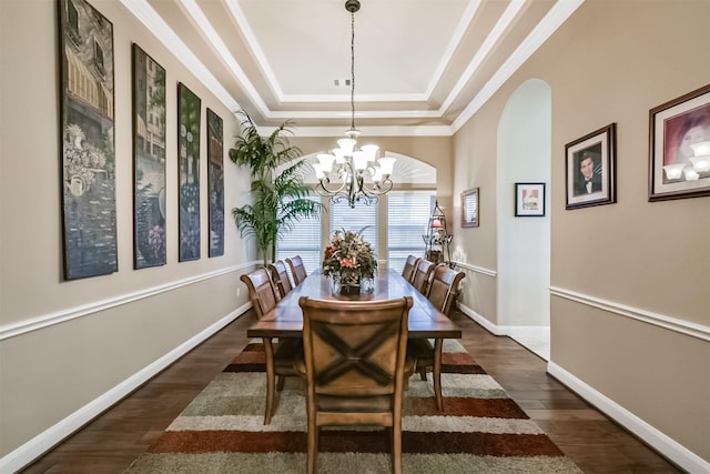 2103 Matagorda Ln, Friendswood, TX 77546 - dining area with a raised ceiling, dark wood finished floors, a chandelier, crown molding, and arched walkways
