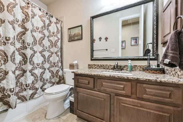 bathroom featuring toilet, vanity, and tile patterned floors