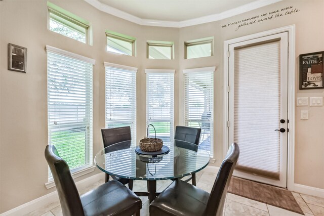 dining room with baseboards, crown molding, and light tile patterned flooring