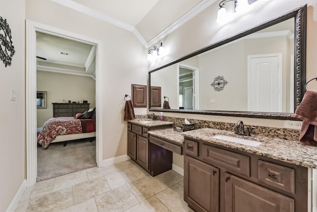 bathroom with ornamental molding, double vanity, baseboards, and connected bathroom