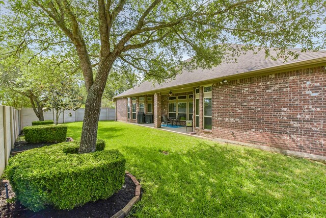 view of yard featuring a patio area and a ceiling fan