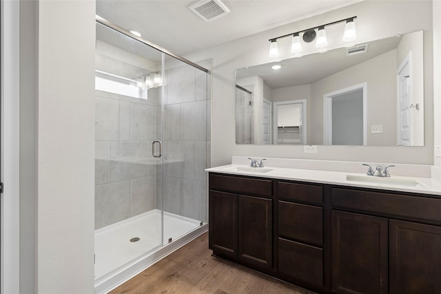 3021 Pampaneria Dr, Conroe, TX 77301 - full bath featuring a stall shower, wood finished floors, and double vanity