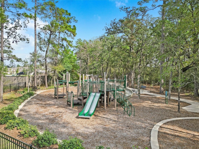 3021 Pampaneria Dr, Conroe, TX 77301 - communal playground featuring fence and view of scattered trees