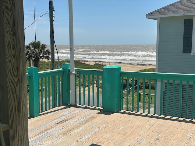 deck with view of water and beach