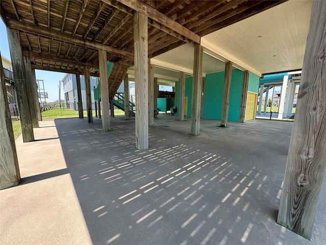 view of patio with stairs and fence