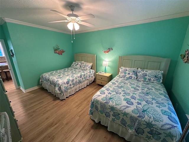 bedroom with ornamental molding, light wood-type flooring, ceiling fan, a textured ceiling, and baseboards