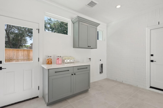 6291/2 Rancho Bauer Dr, Houston, TX 77079 - bar area featuring ornamental molding, light tile patterned flooring, and brick wall