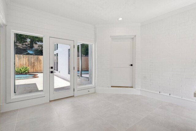 6291/2 Rancho Bauer Dr, Houston, TX 77079 - tiled empty room with crown molding and brick wall