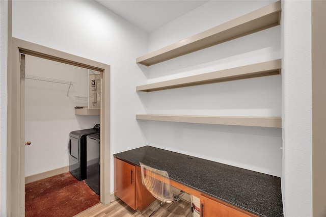 mudroom featuring washer and clothes dryer, light wood-type flooring, and built in study area